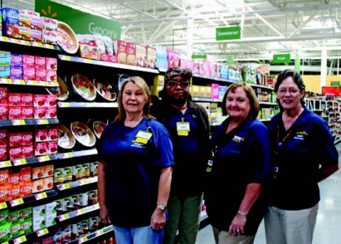 From left to right are the four employees who have been with the La Grange Walmart since it opened here in 1985: Connie Jakobeit, Doris McKenzie, Shawn Smith and Theah Fleck. They’ll be making the move with the rest of their co-workers to the new Walmart SuperCenter that opens Oct. 23. They are shown here in the new store, which is just east on Travis St. from the old store