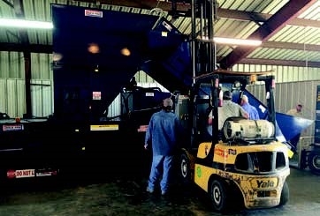 Workers squeeze a new baling machine into the barn at the Fayette County Recycling Center. The aptly-named “Max-Pak” baler will replace an existing unit that has been in use at the center since the 1990s.