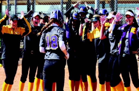 La Grange sophomore catcher Hatti Moore is greeted by her teammates as she trots to the plate after a three-run home run against Little Cypress Mauriceville.