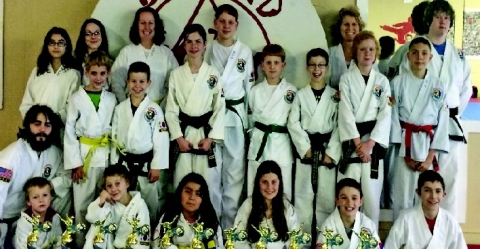 Local Tae Kwon Do participants show off some of the hardware they won at a recent meet in Giddings